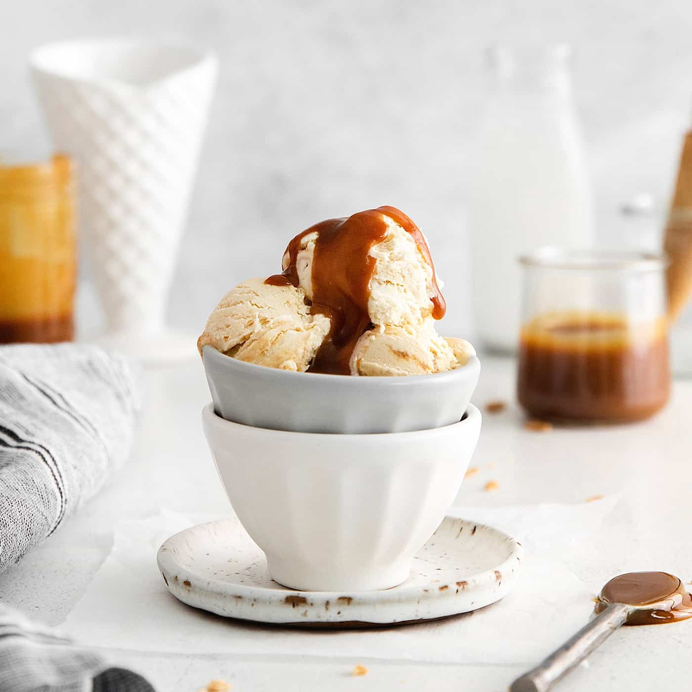 A bowl of ice cream topped with caramel sauce