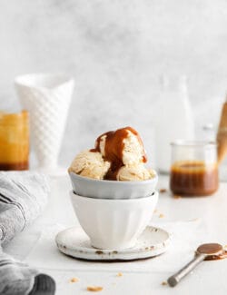 A bowl of ice cream topped with caramel sauce