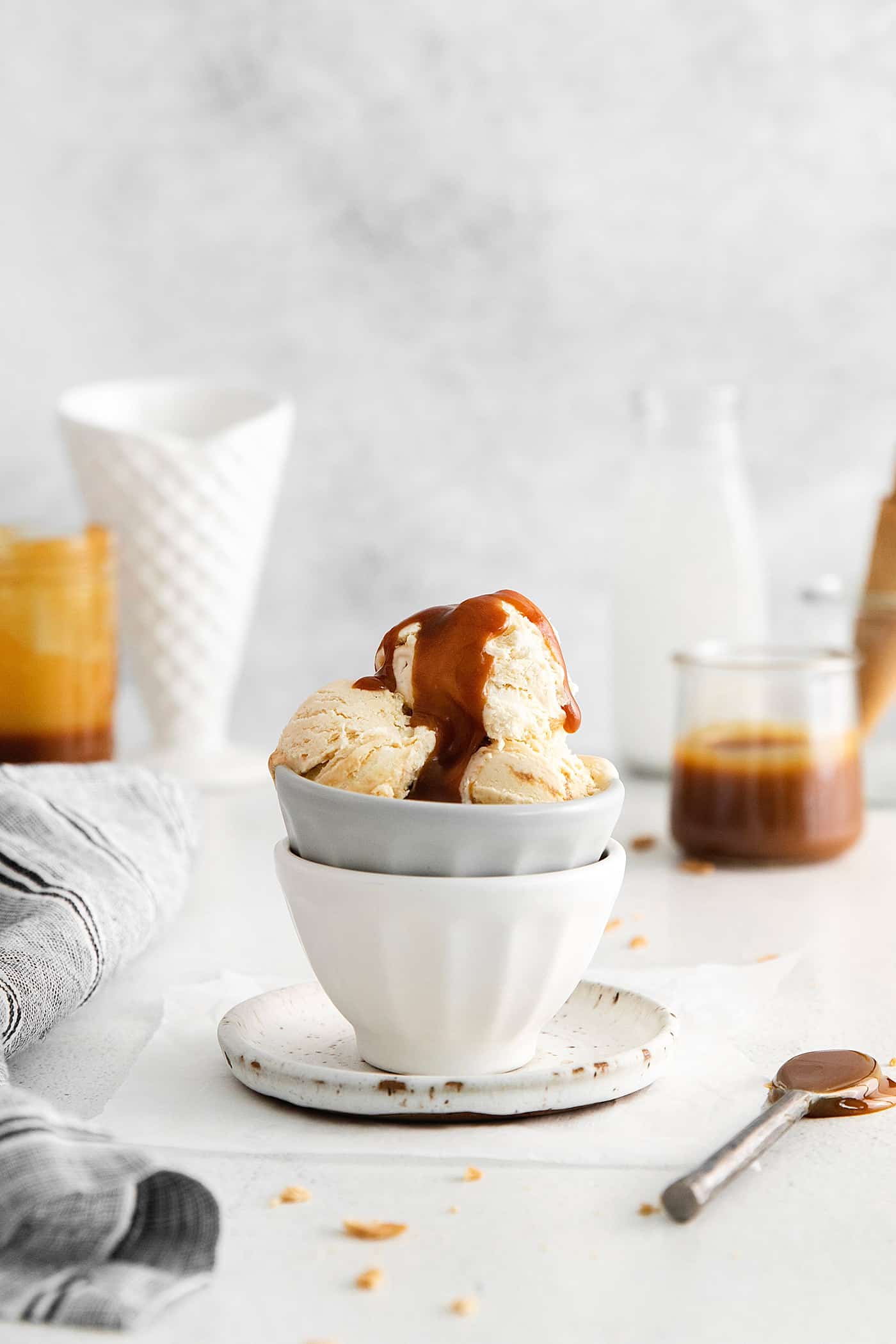 A bowl of ice cream topped with caramel sauce