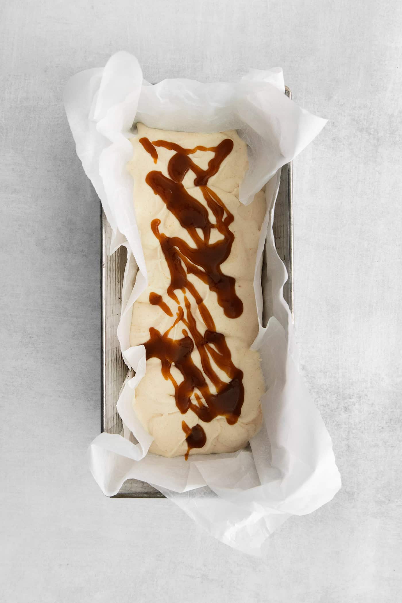 A layer of ice cream topped with salted caramel drizzle