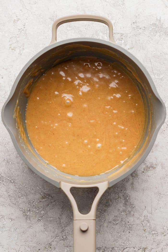 Peanut butter and condensed milk mixture in saucepan.