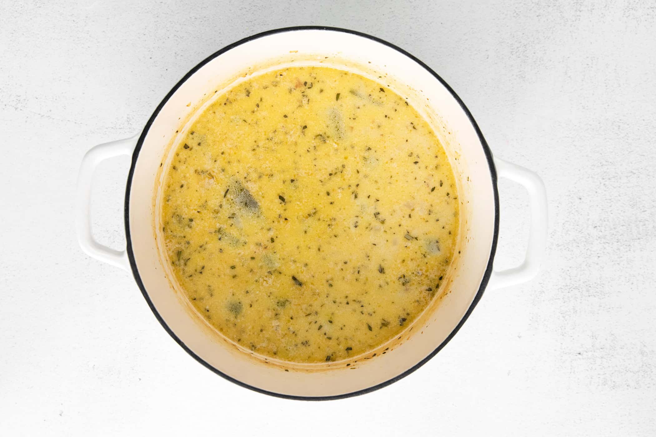 shrimp corn chowder in a white Dutch oven