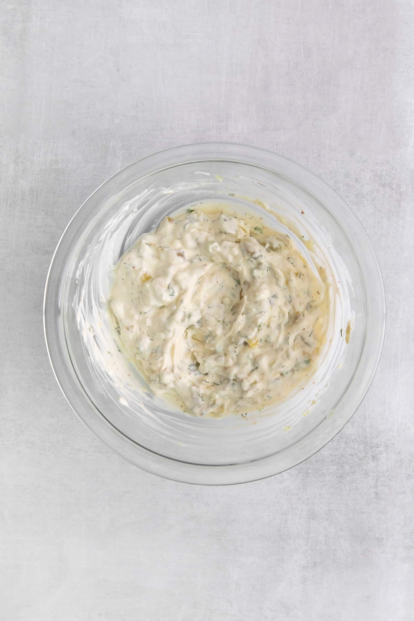 Overhead view of a mixing bowl of tartar sauce