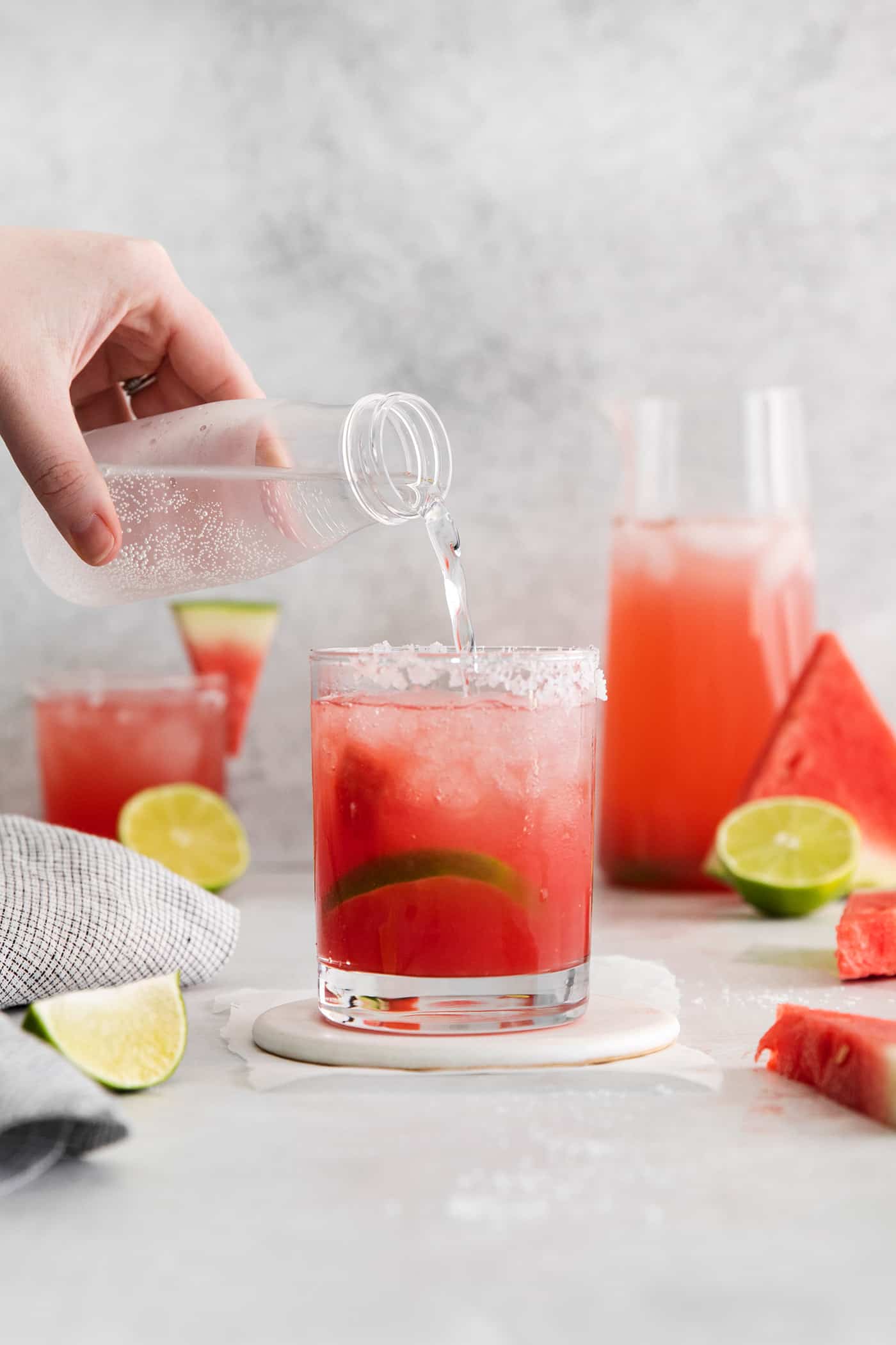 topping off a watermelon margarita with club soda