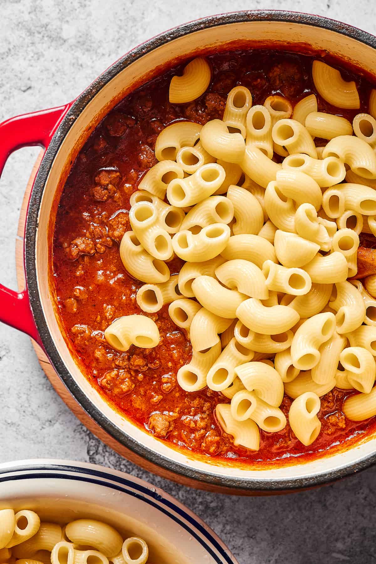 Elbow macaroni added to tomato sauce