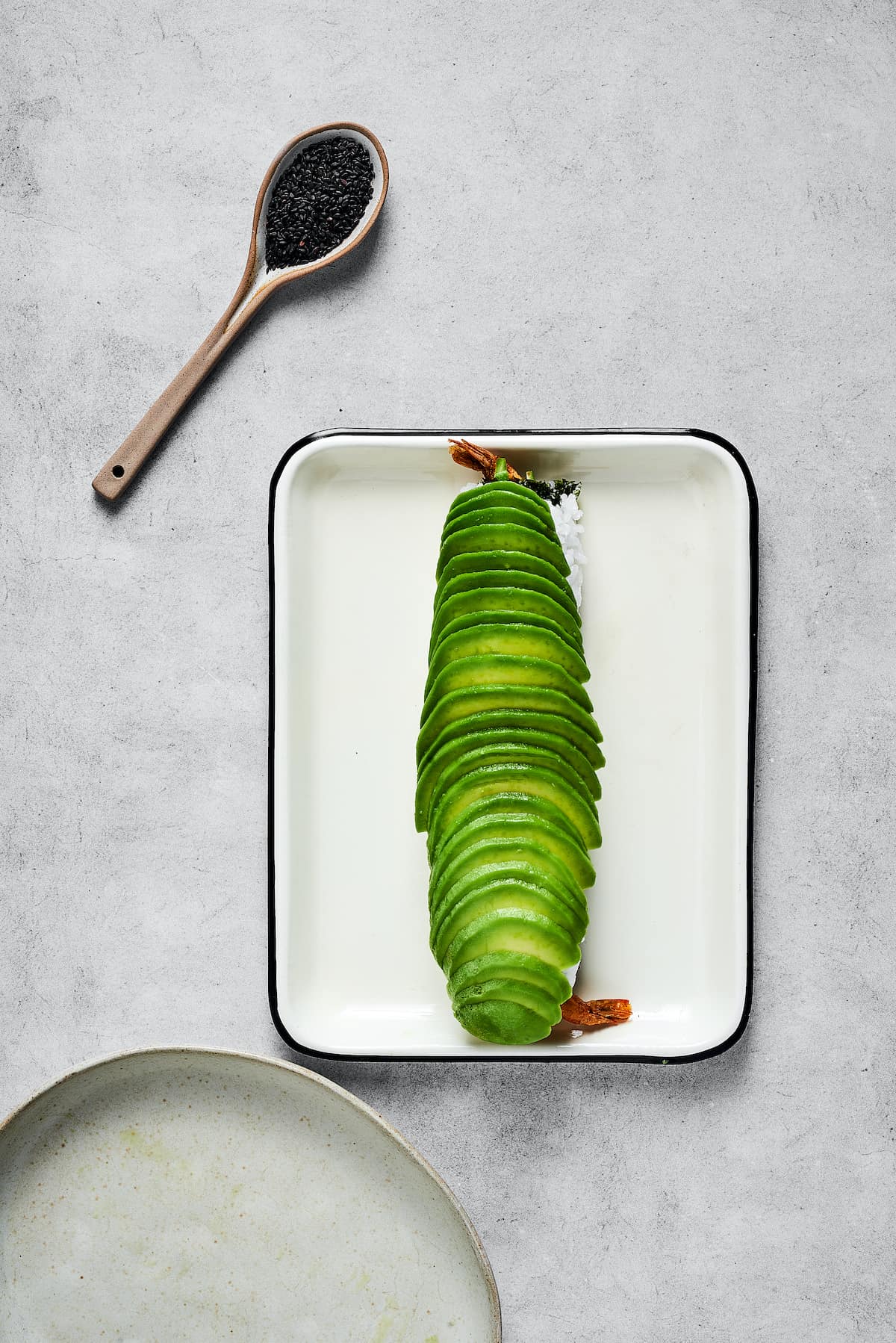 Slices of avocado on a sushi roll.