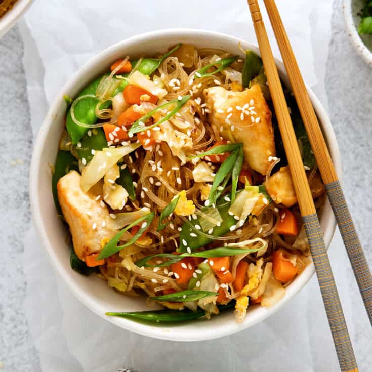 Overhead view of a bowl of pad woon sen with chopsticks