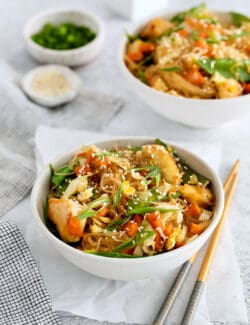 Angled view of a bowl of Thai glass noodle stir fry with chicken