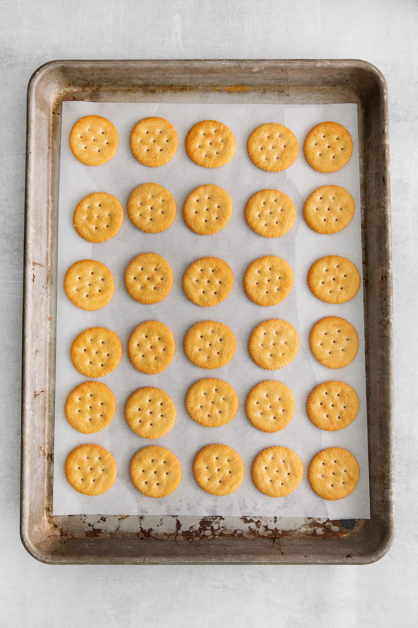 Ritz crackers on a baking sheet