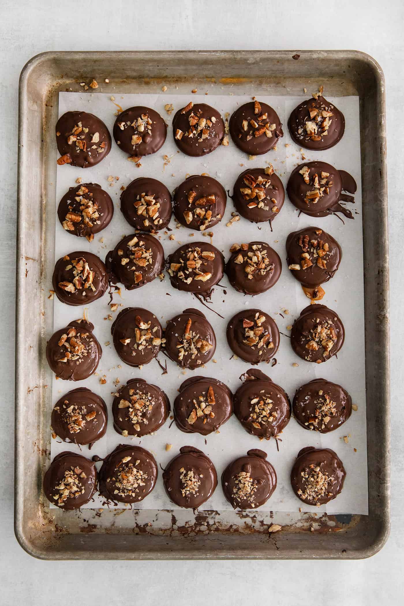 Overhead view of a baking sheet of Ritz crackers caramel cookies