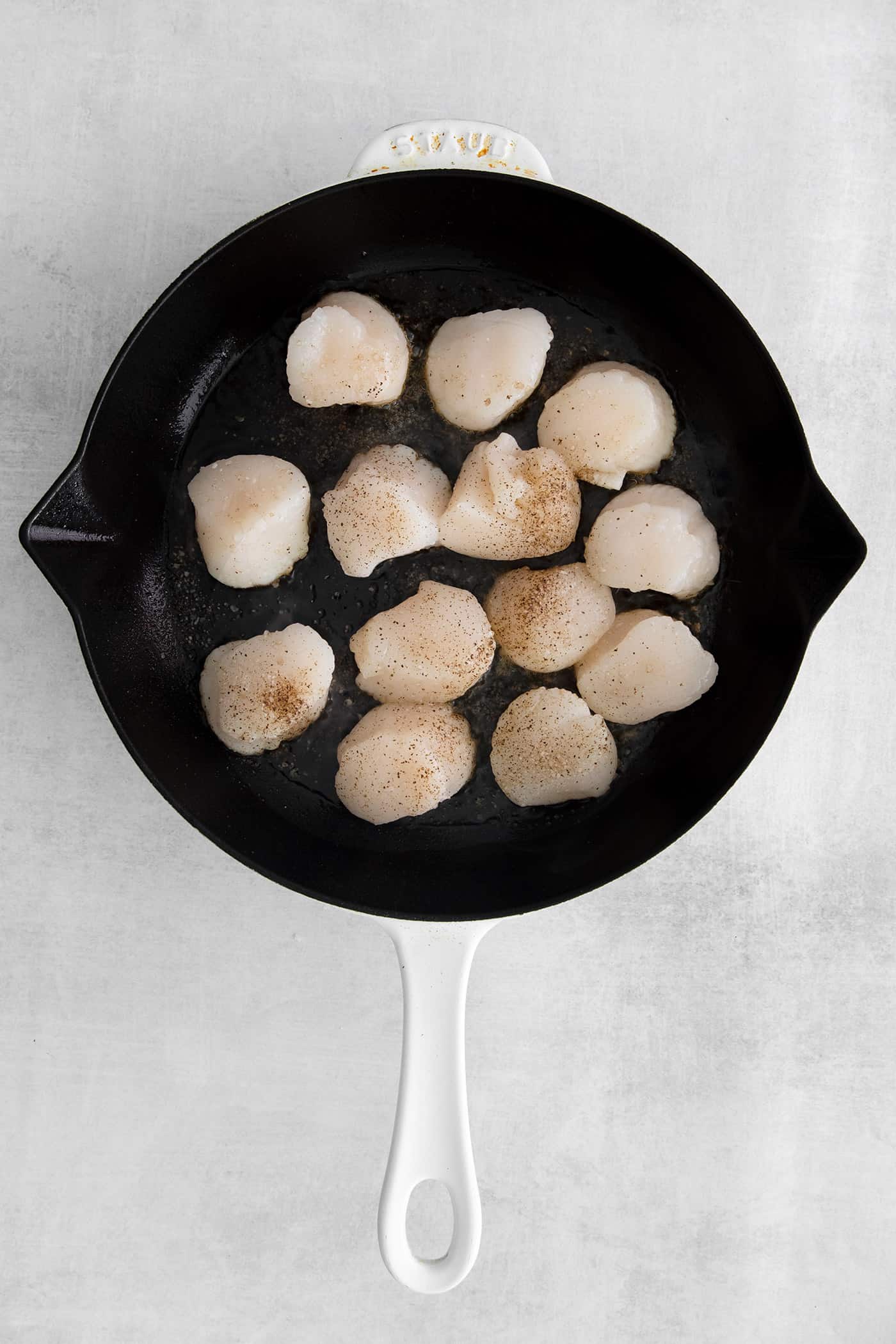 Sea scallops cooking in a skillet
