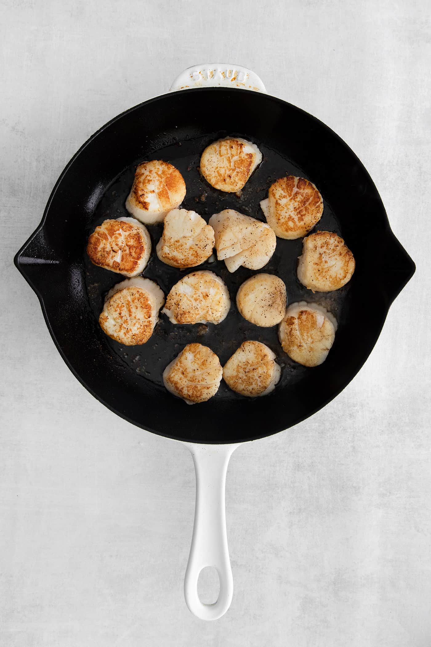 Overhead view of scallops in a skillet