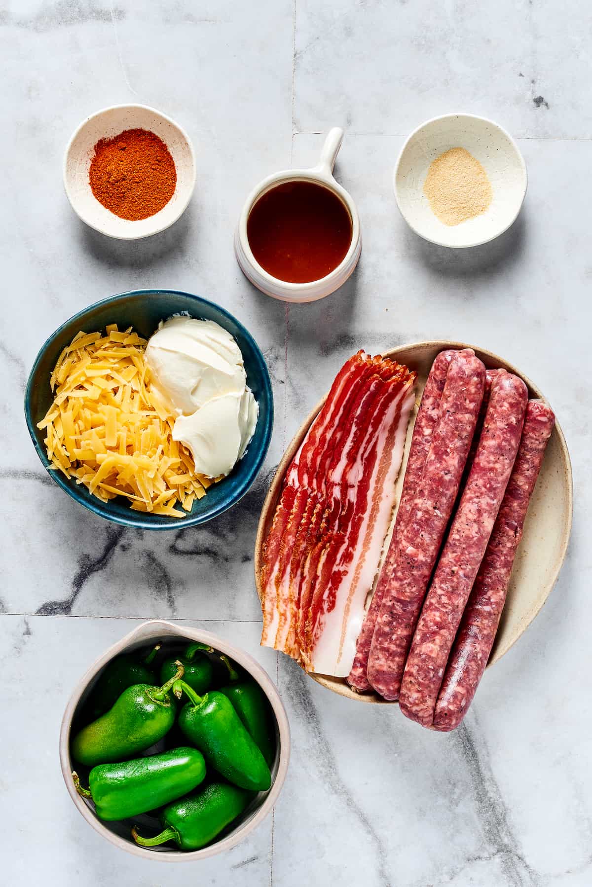 If you love jalapeno poppers, you are going to LOVE these Armadillo Eggs - cheese-stuffed jalapenos wrapped in bacon and sausage. Yum! Overhead view of armadillo egg ingredients