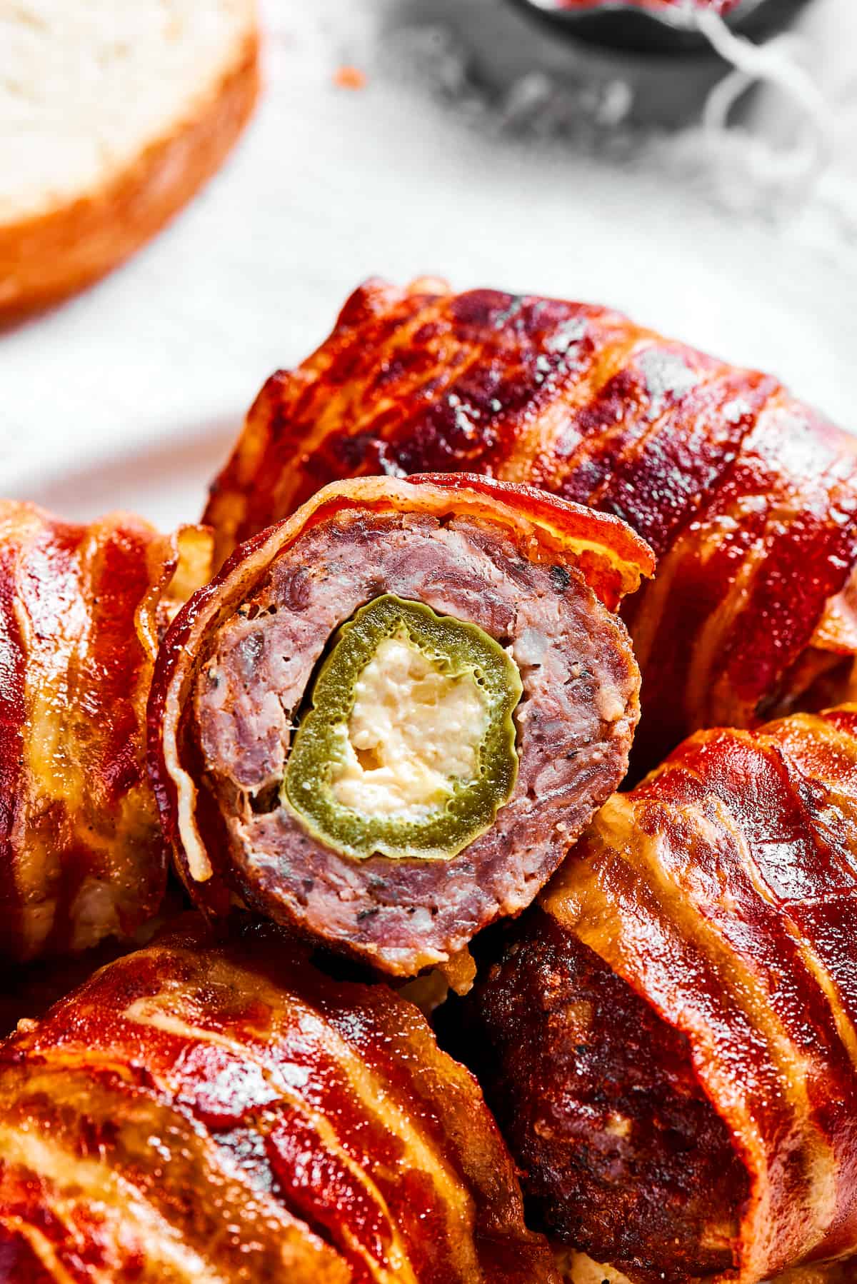 If you love jalapeno poppers, you are going to LOVE these Armadillo Eggs - cheese-stuffed jalapenos wrapped in bacon and sausage. Yum! Close-up of an armadillo egg