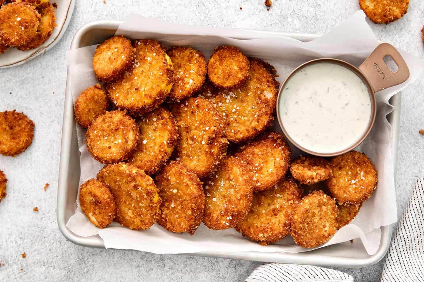 Overhead view of fried squash with a dish of ranch dressing