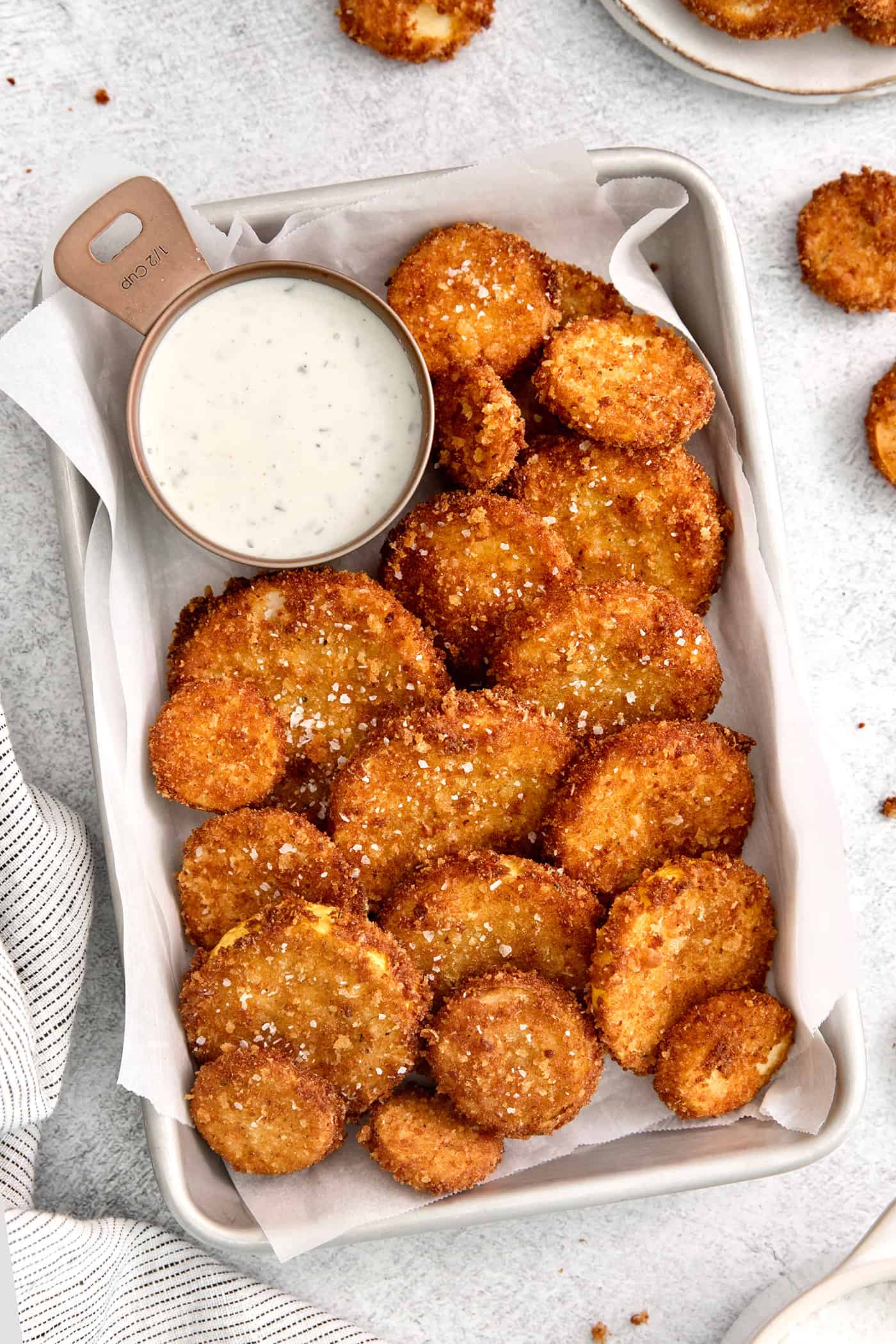 Overhead view of fried squash with a dish of ranch