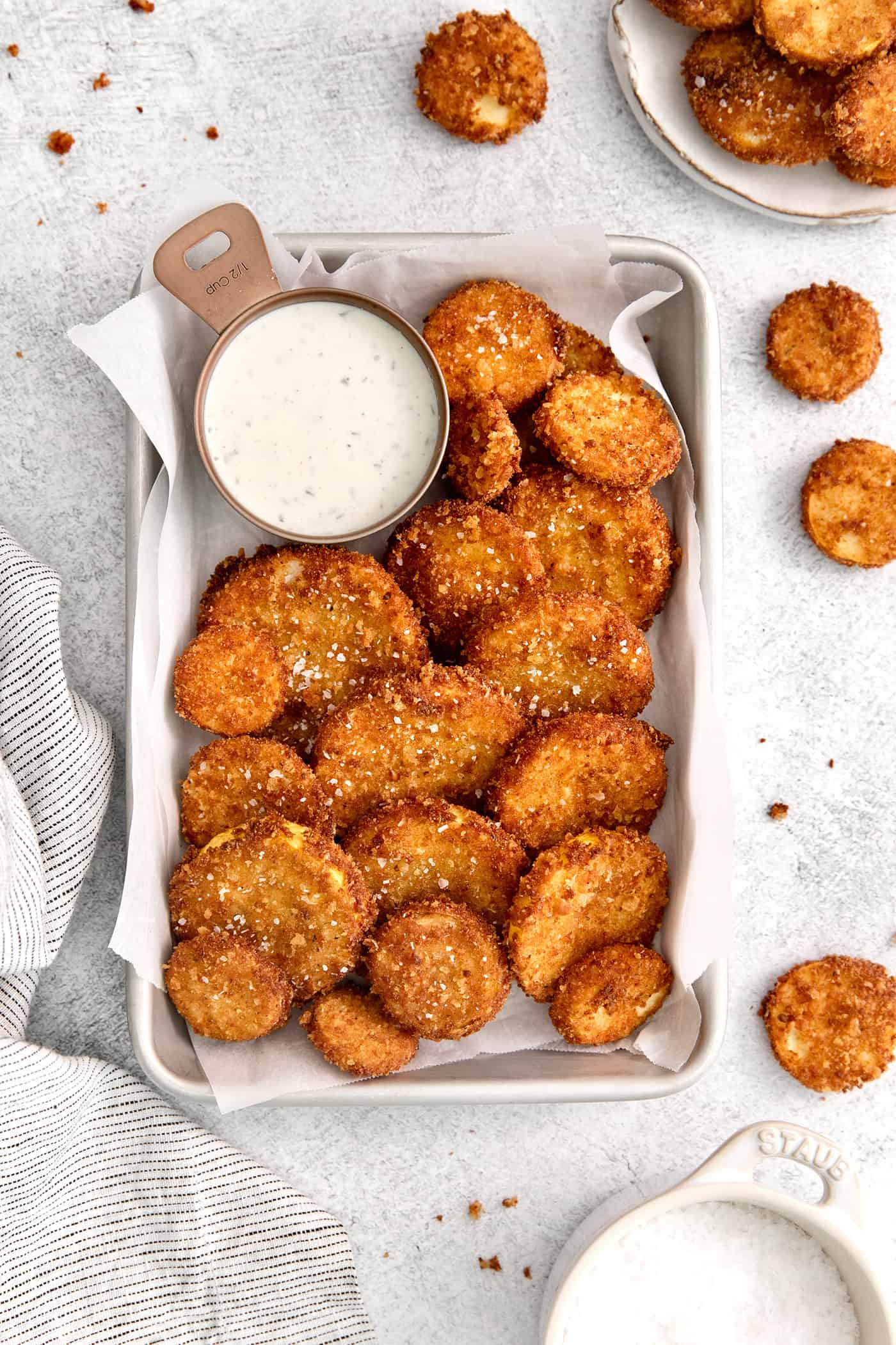 Fried squash on a platter with a dish of ranch