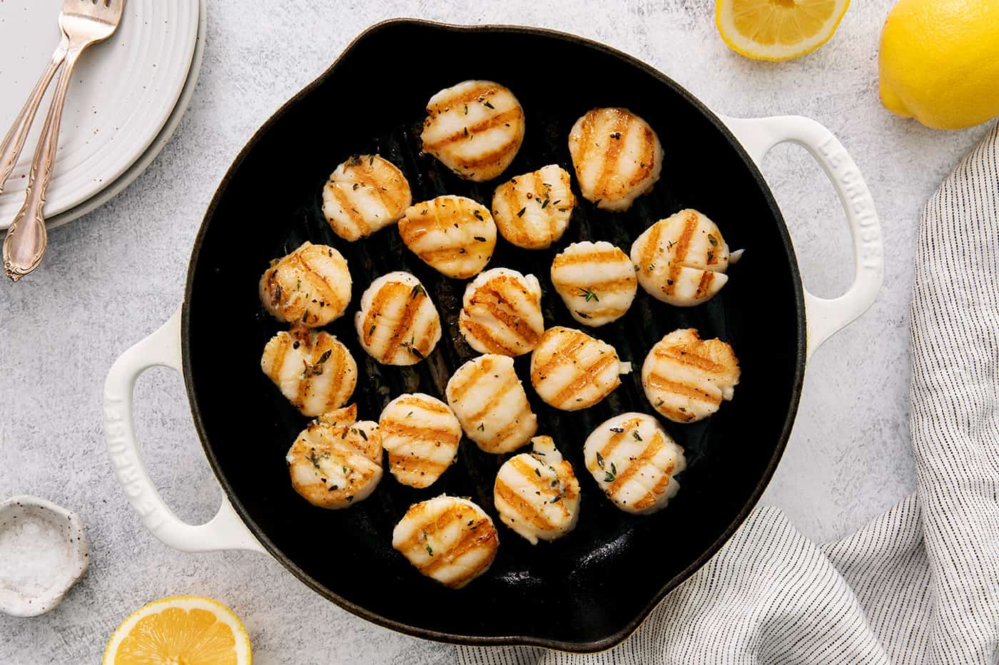 a grill pan with scallops in it