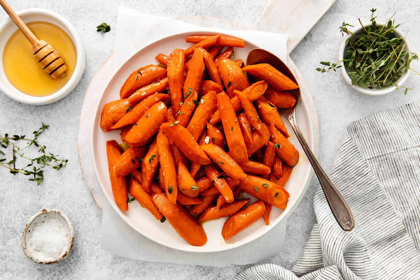 Overhead view of honey garlic carrots on a white plate