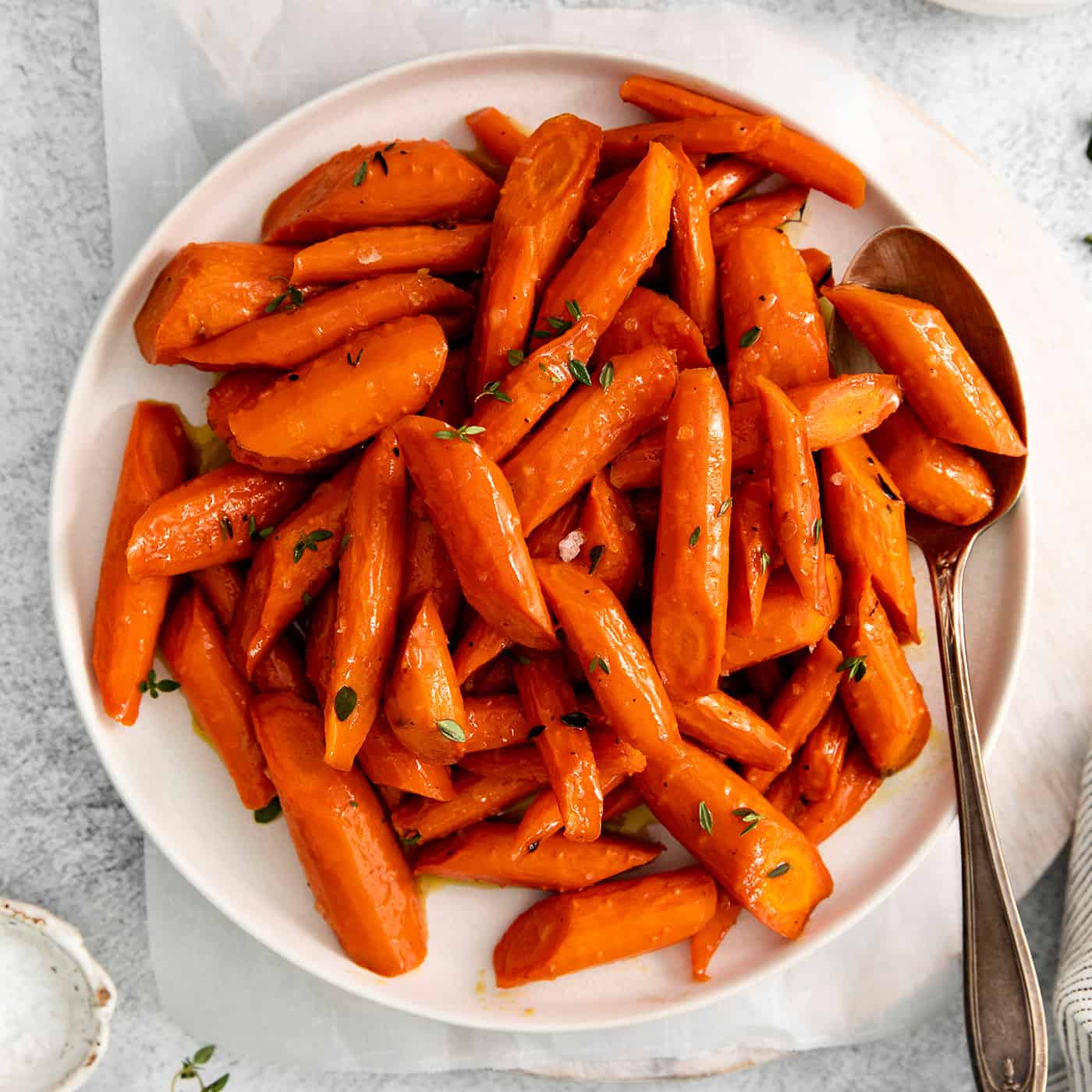 Overhead view of honey garlic carrots on a white plate