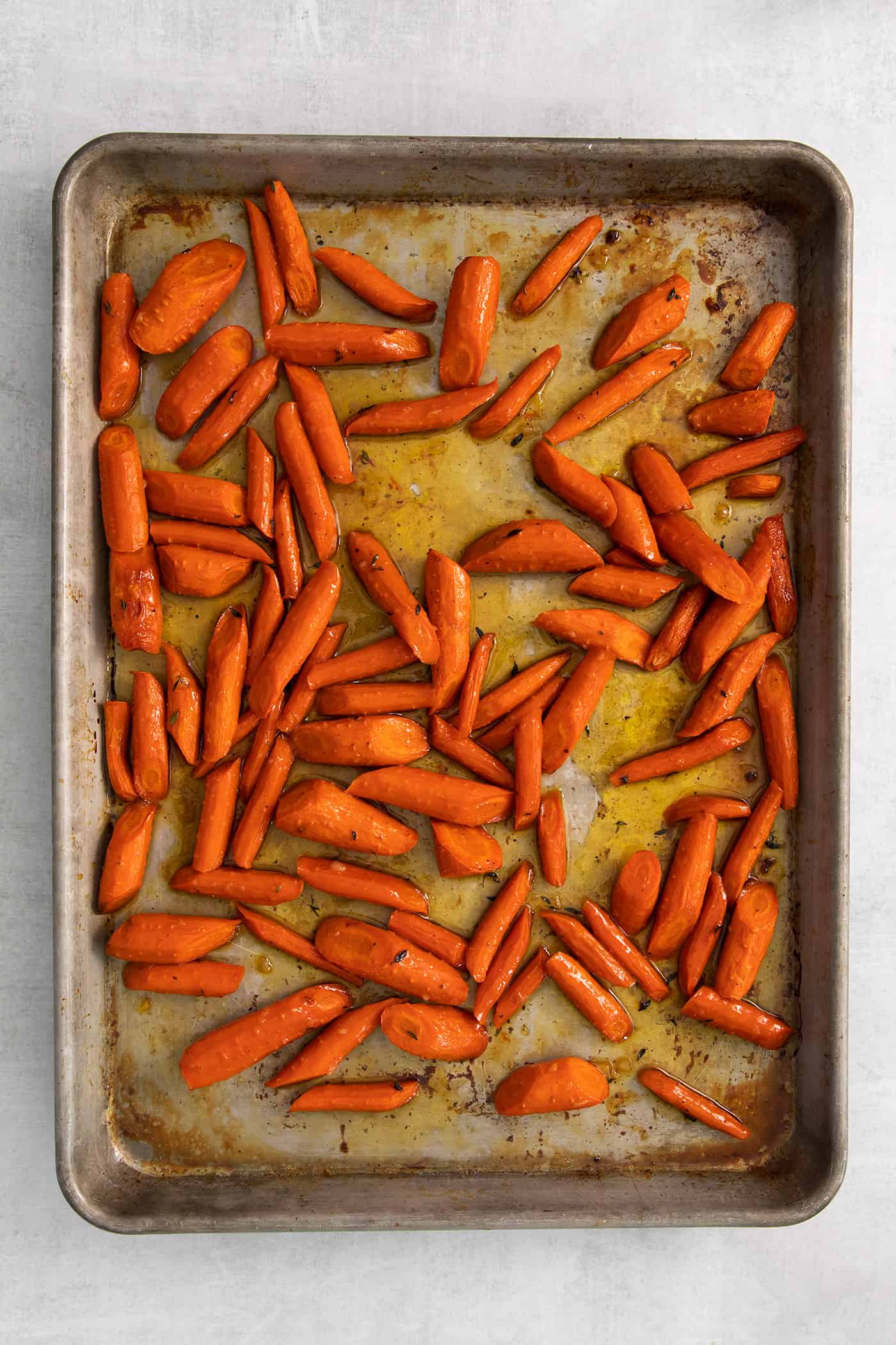 Overhead view of roasted carrots on a baking sheet