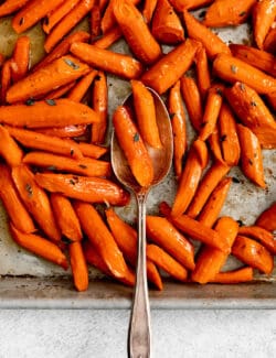 Overhead view of honey garlic roasted carrots on a baking sheet