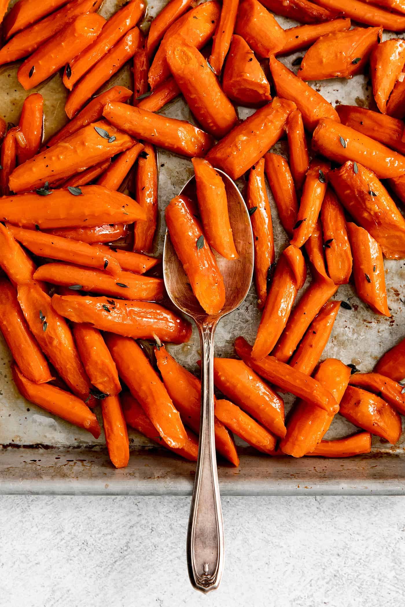 Overhead view of honey garlic roasted carrots on a baking sheet