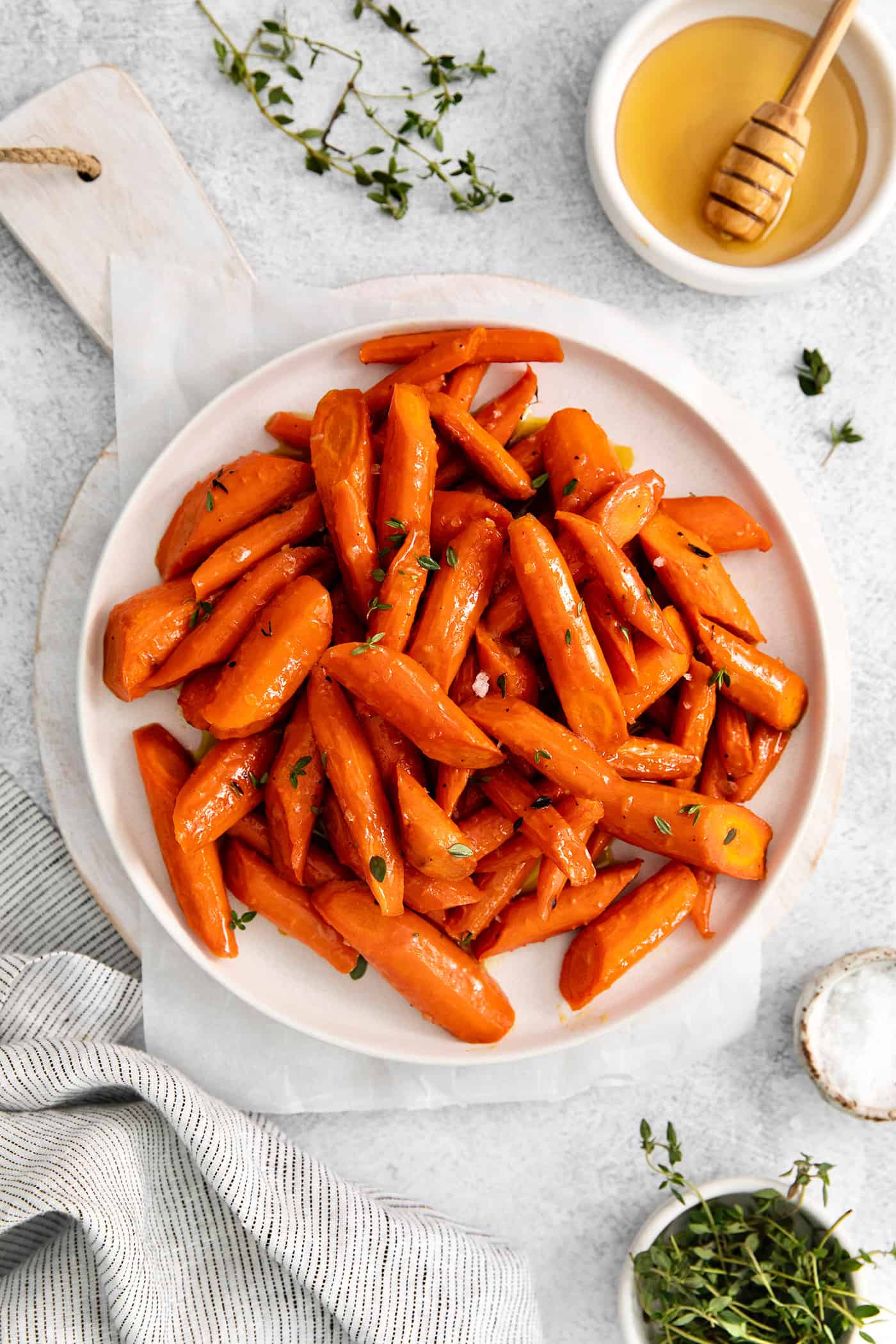 Overhead view of roasted carrots on a white plate