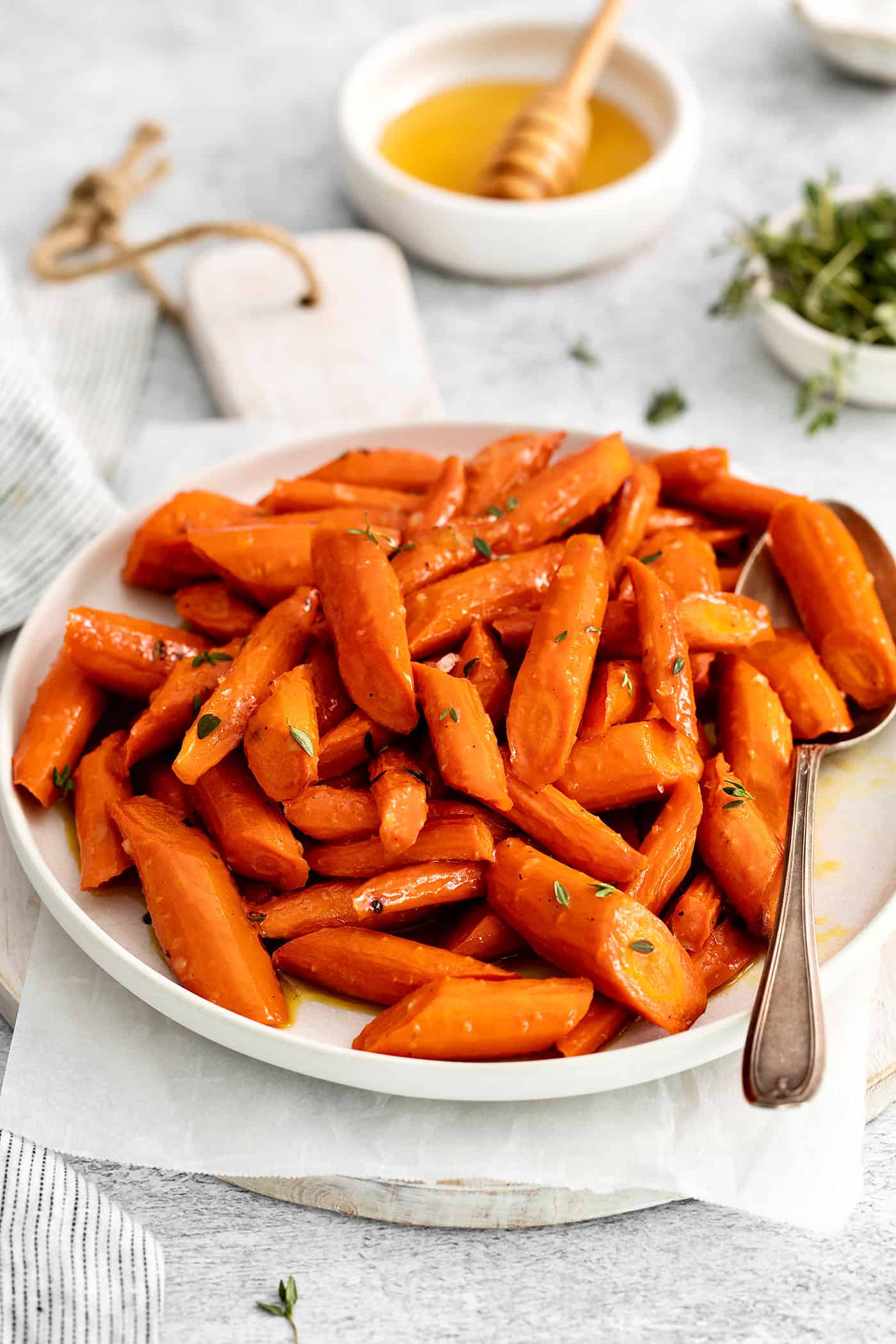 Angled view of honey garlic carrots on a white plate