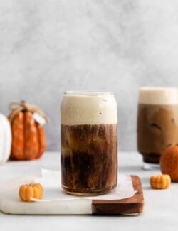 A glass of cold brew topped with pumpkin cream
