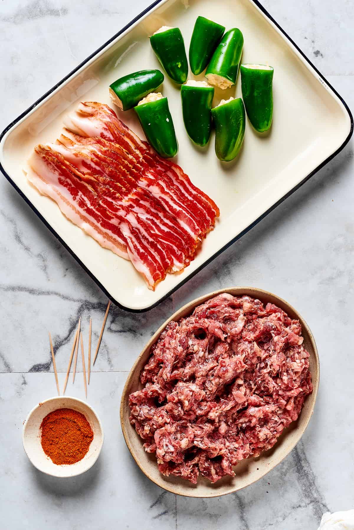 jalapenos stuffed with creamy mixture, plus sausage and bacon for wrapping