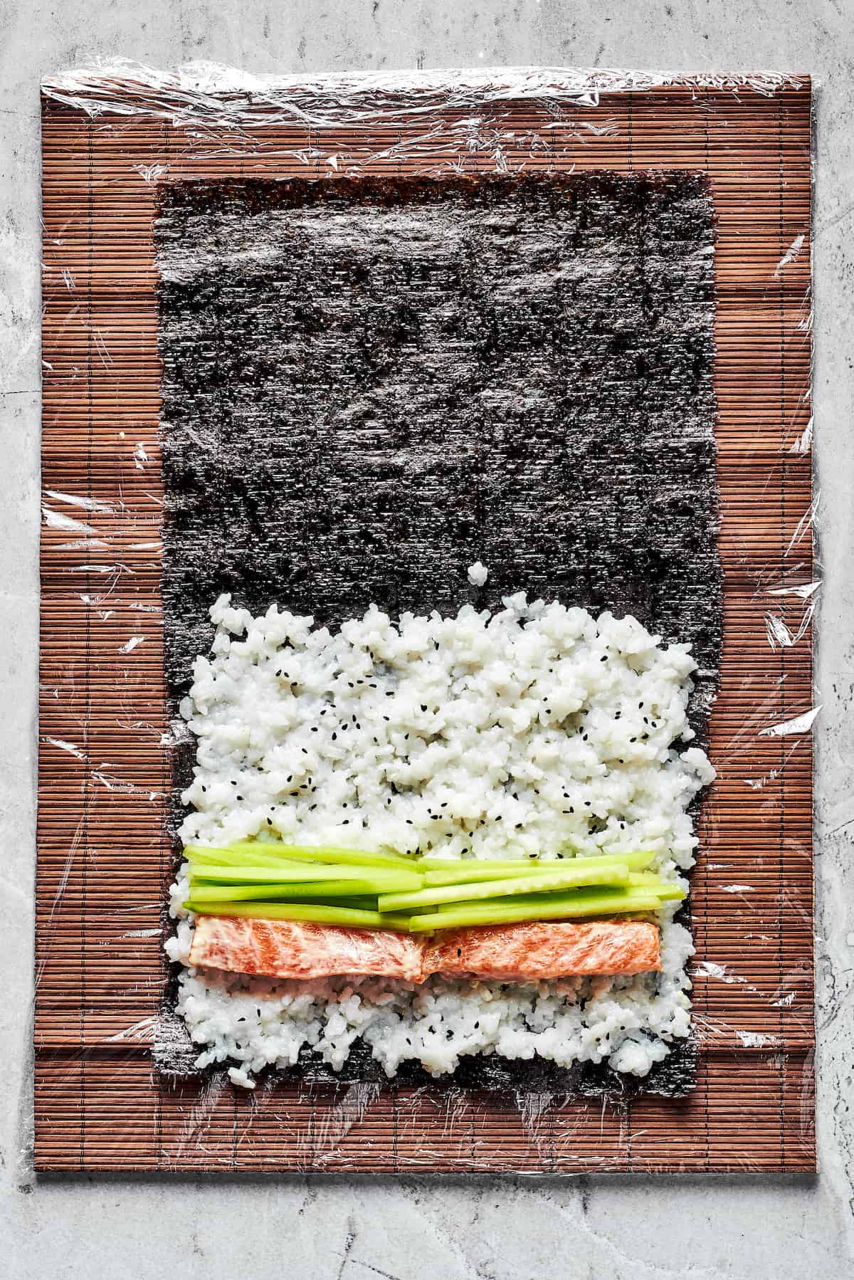 Rice, salmon, and avocado on nori sheets