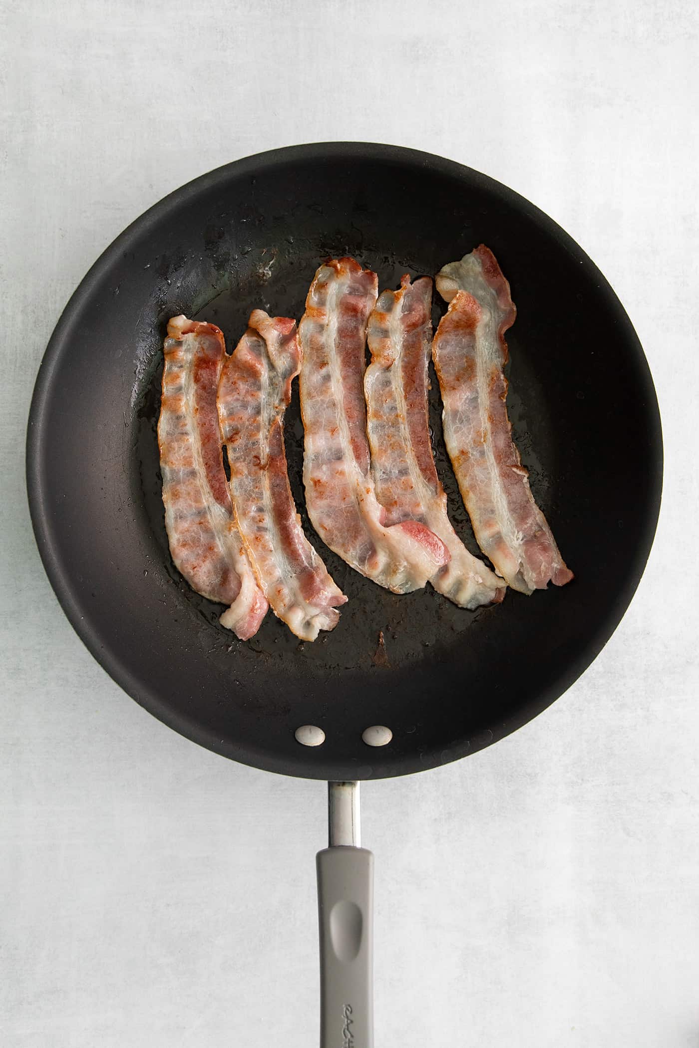 Slices of bacon in a frying pan