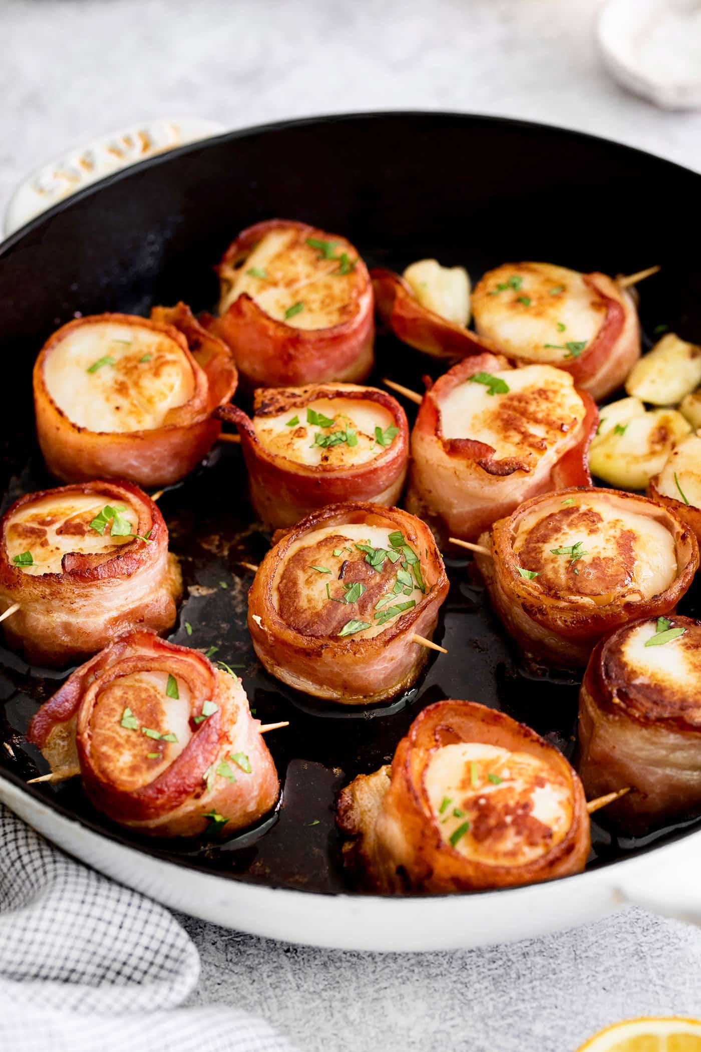 Pan seared scallops with bacon in a skillet