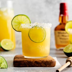 A bourbon margarita on a wooden coaster