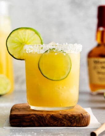 A bourbon margarita on a wooden coaster