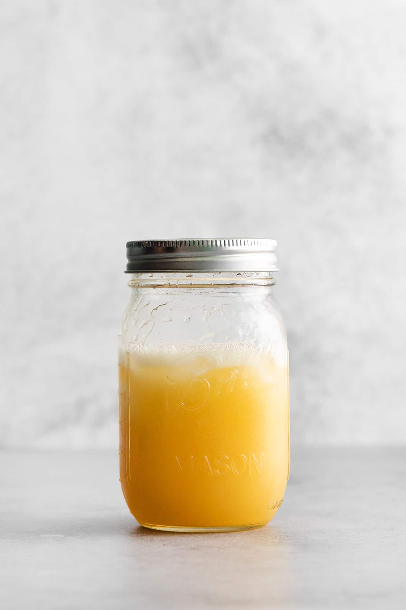 A mason jar with whiskey margarita ingredients