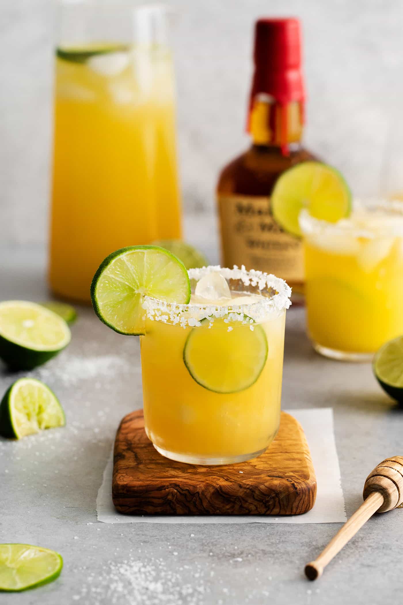 A bourbon margarita on a wooden coaster