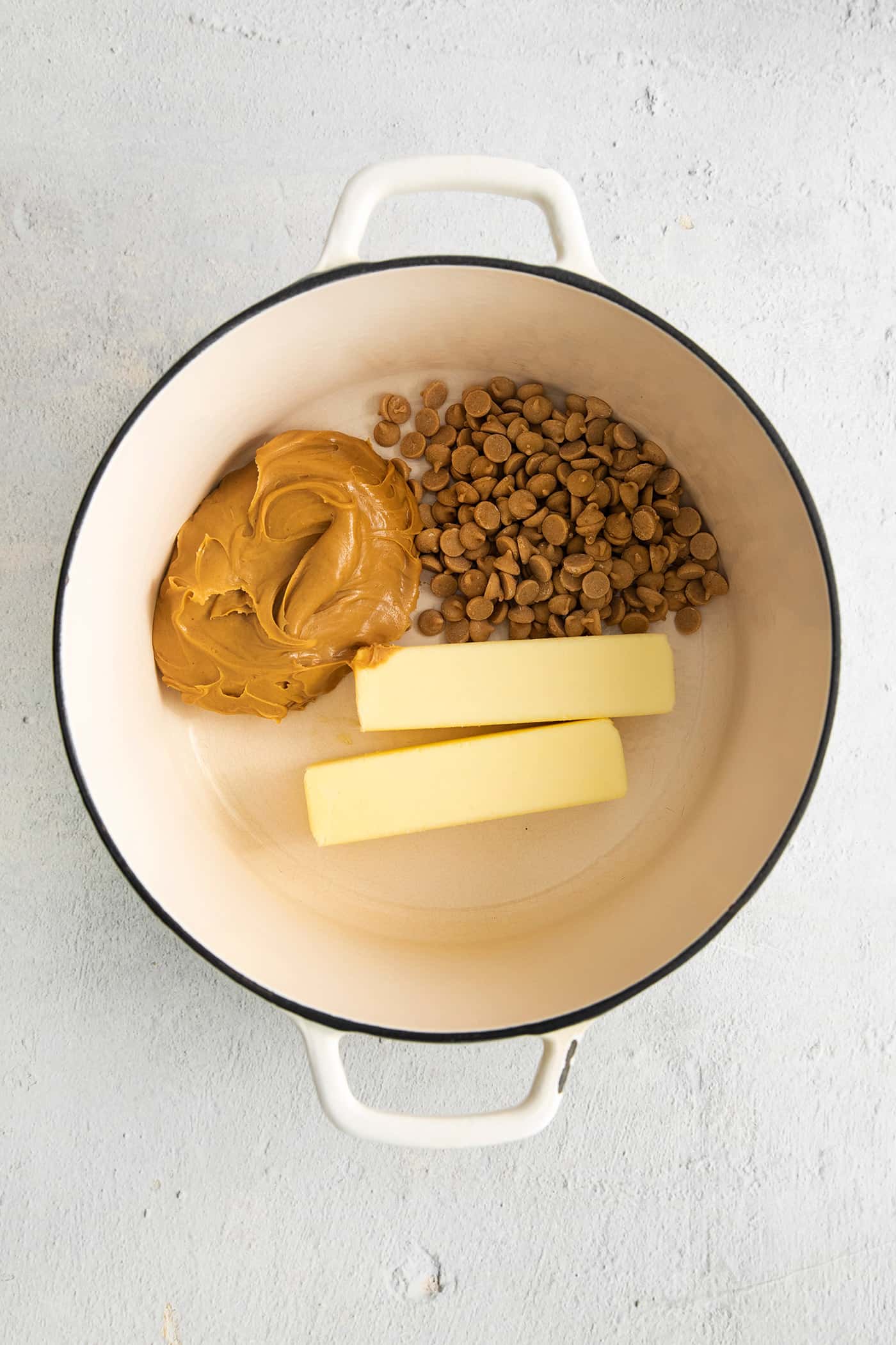 Peanut butter, butter, and peanut butter chips in a saucepan