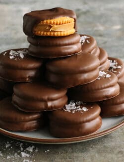 a stack of cookies made with Ritz crackers, peanut butter and chocolate dip