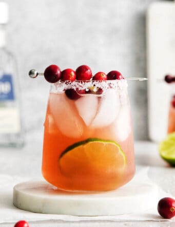 Cranberry margarita on a white coaster