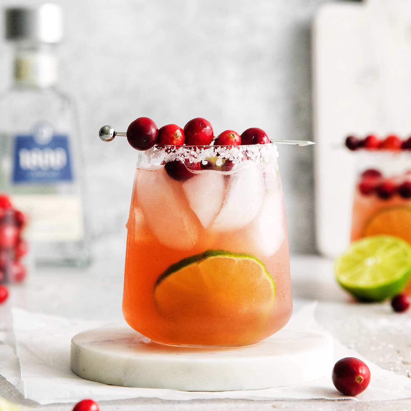 Cranberry margarita on a white coaster