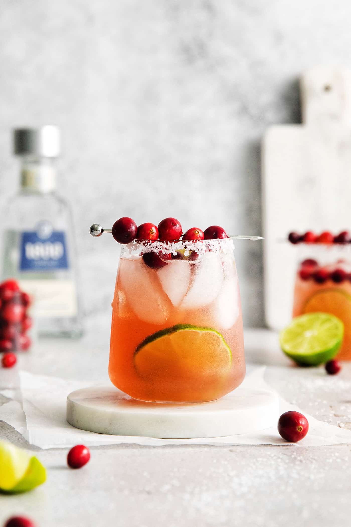 Cranberry margarita on a white coaster