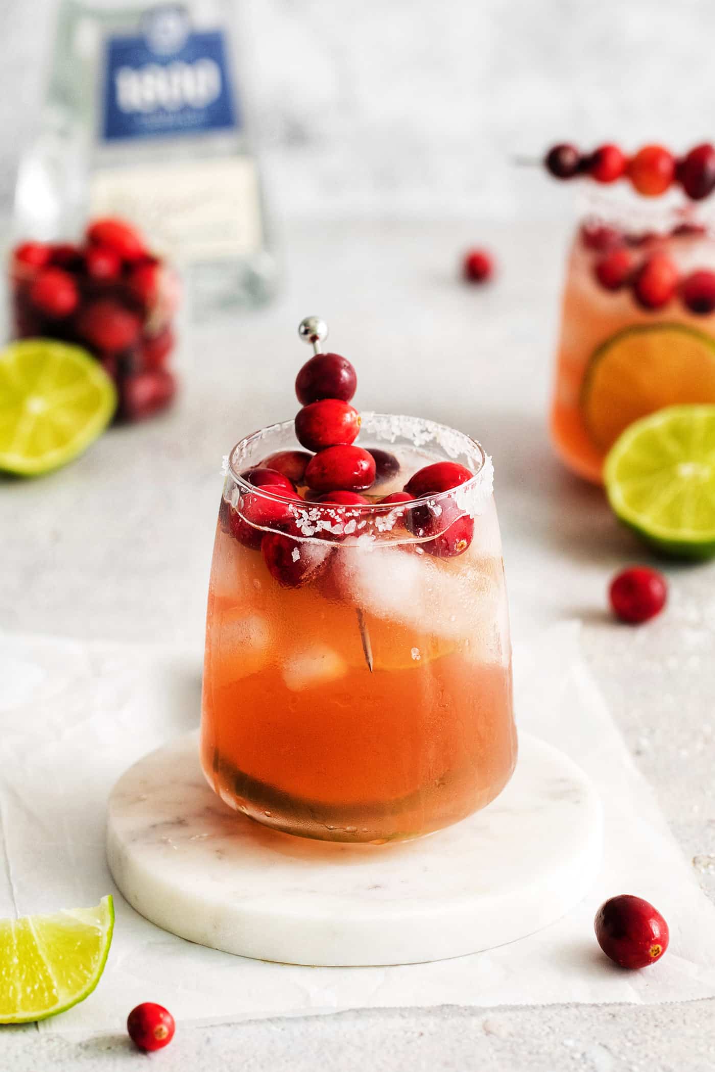 A cranberry margarita on a white coaster.