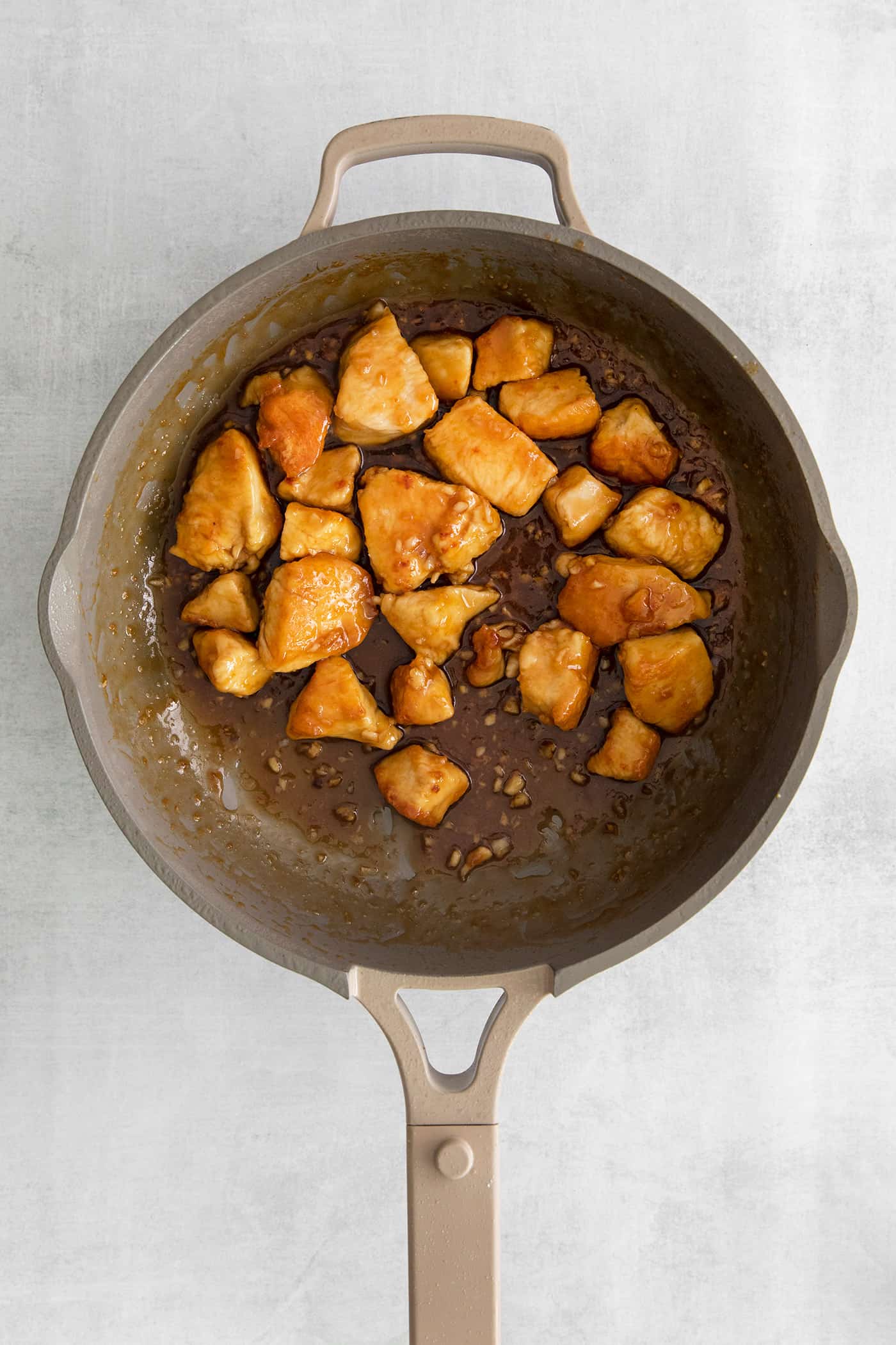 Cooked pieces of chicken in a cast iron skillet