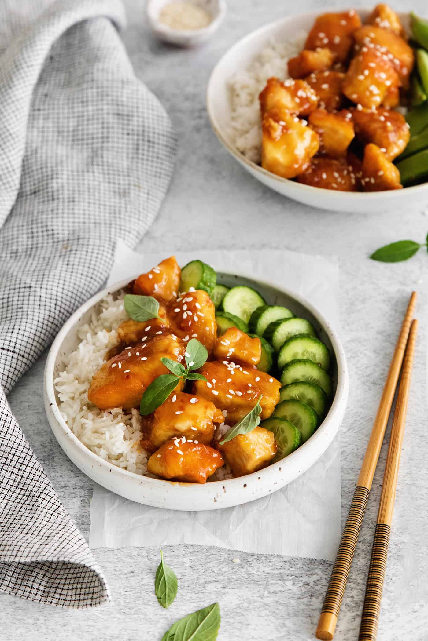 A chicken rice bowl next to chopsticks