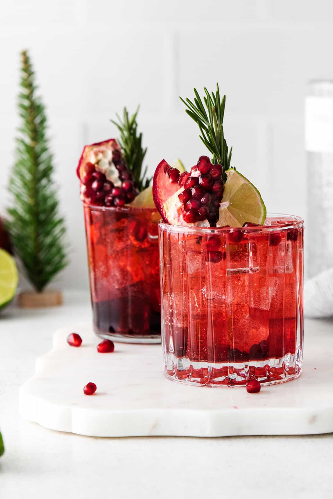 Two glasses of pomegranate gin & tonic cocktails.