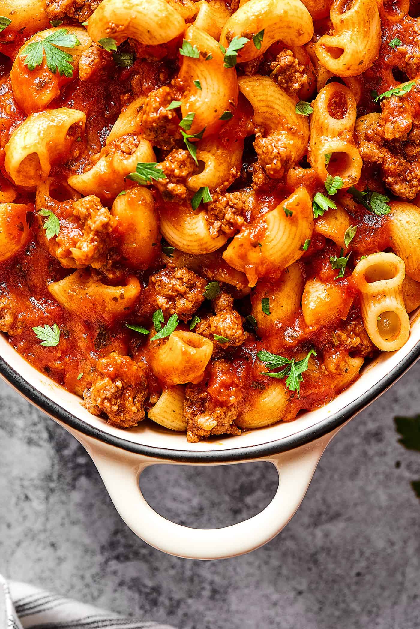 overhead view of dish made of pasta, beef, and tomato sauce