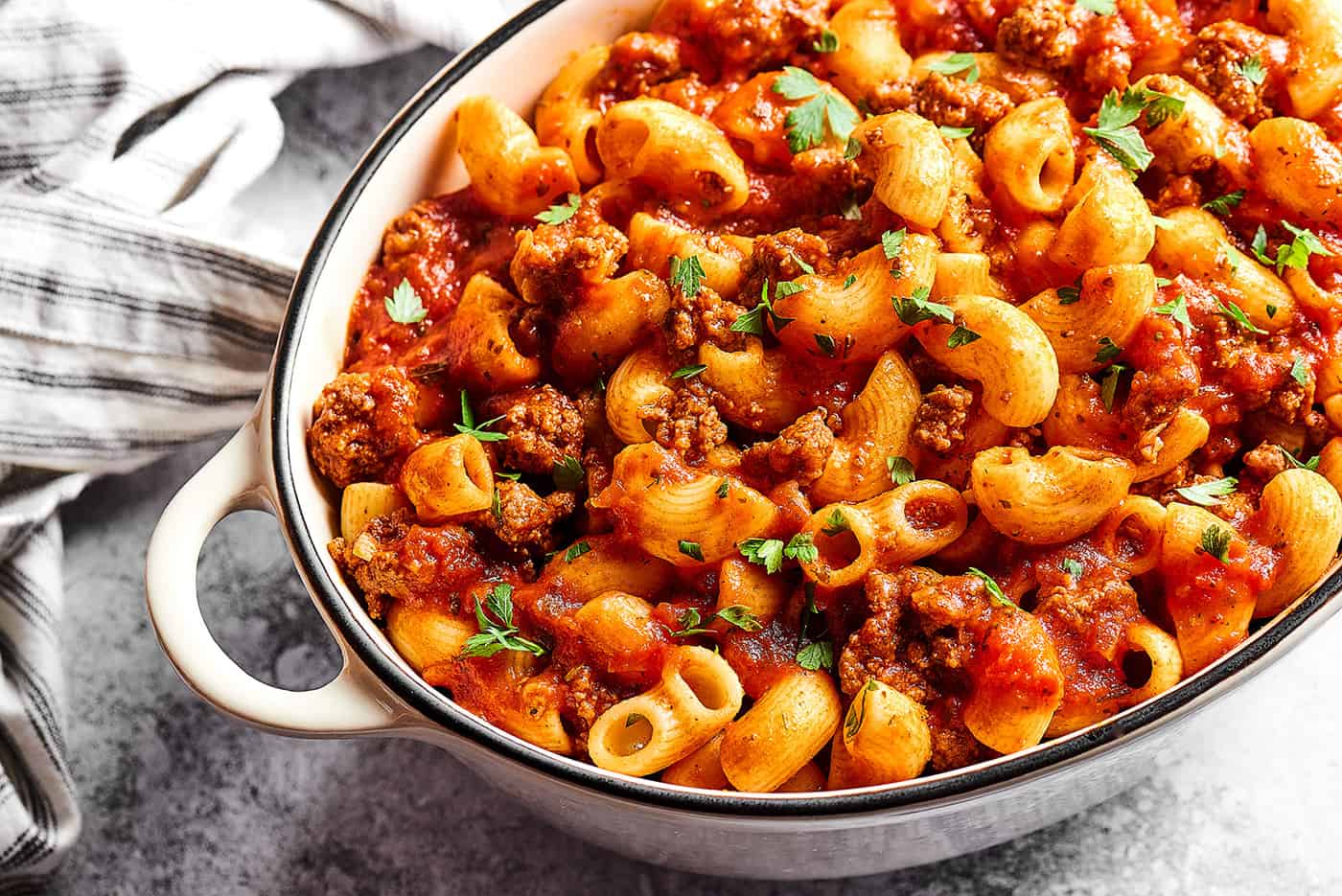 a large white dish of beefaroni