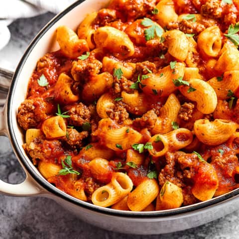 a white Dutch oven full of beefaroni